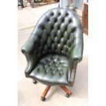 A GREEN LEATHER BUTTON-BACK SWIVEL CHAIR