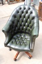 A GREEN LEATHER BUTTON-BACK SWIVEL CHAIR