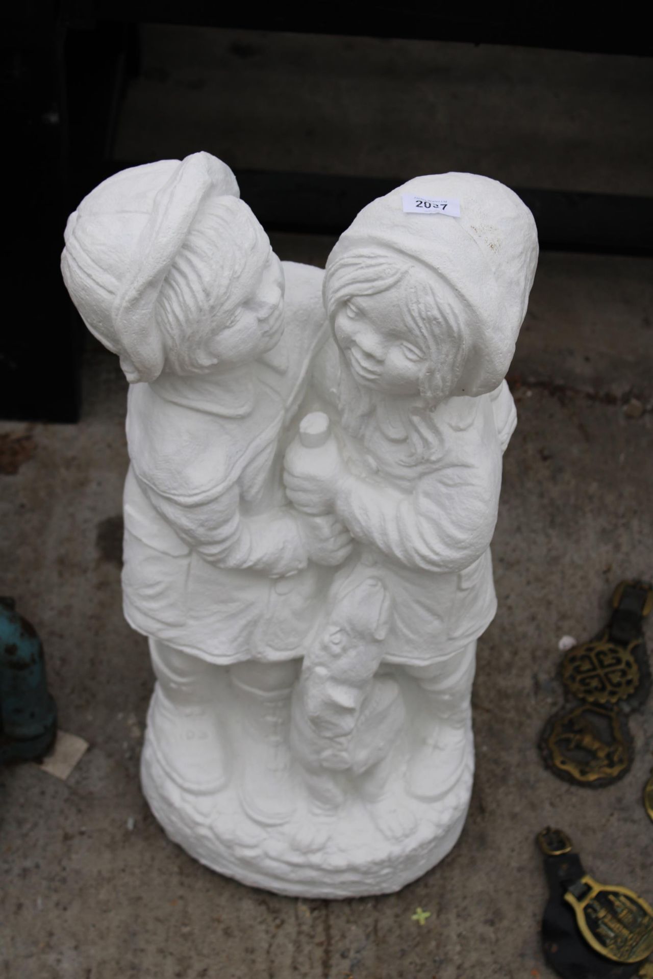 A WHITE PAINTED CONCRETE GARDEN FIGURE OF TWO CHILDREN