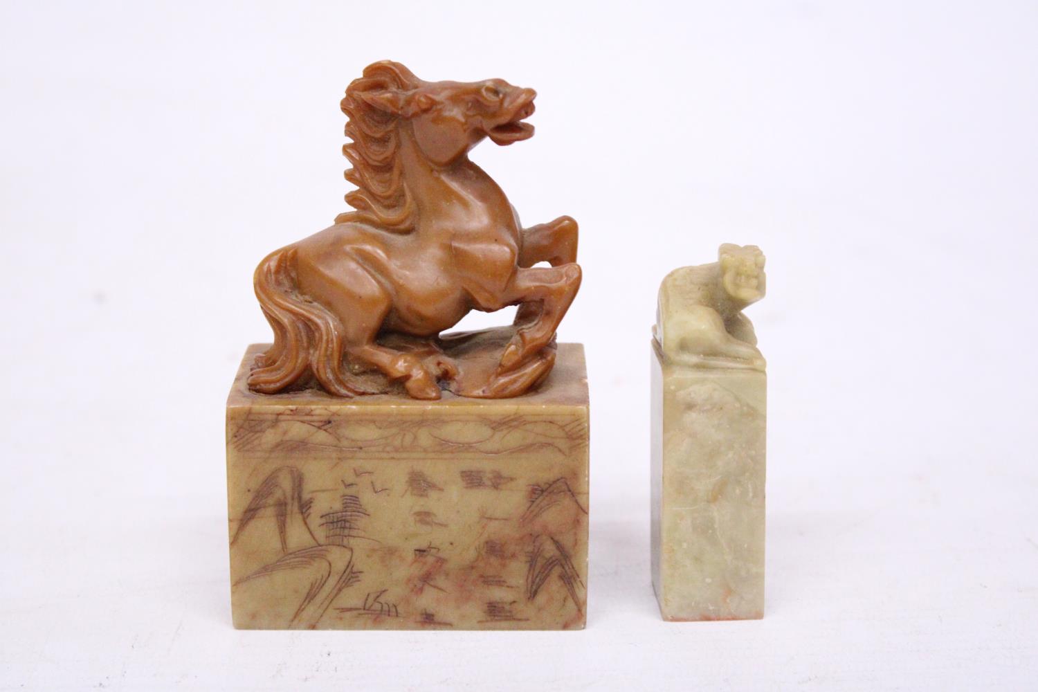 A CHINESE CARVED SOAPSTONE SEAL DEPICTING A REARING HORSE TOGETHER WITH A LION SEAL CARVING