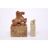 A CHINESE CARVED SOAPSTONE SEAL DEPICTING A REARING HORSE TOGETHER WITH A LION SEAL CARVING