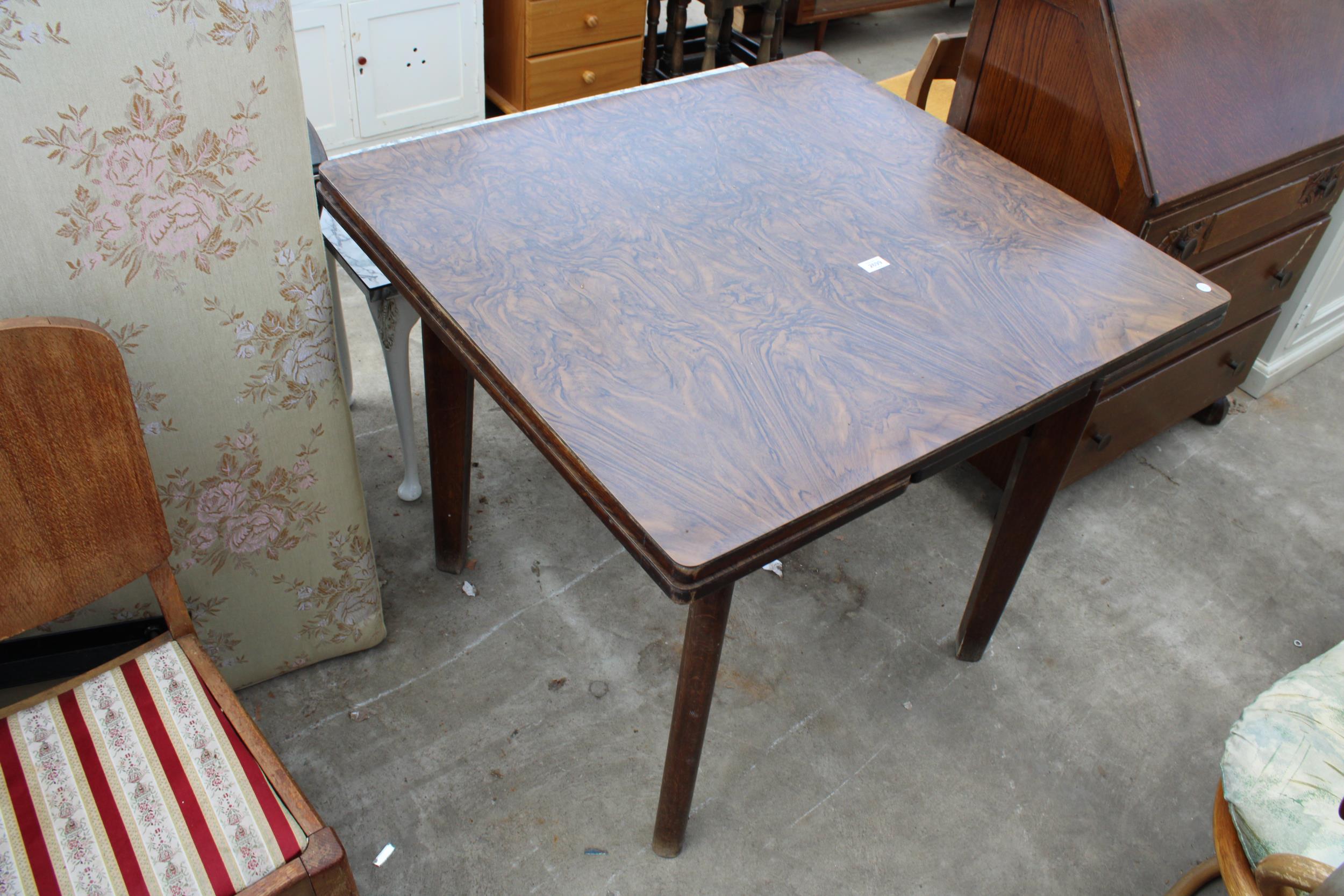A MID 20TH CENTURY OAK DRAW-LEAF TABLE WITH FORMICA WALNUT TOP