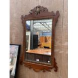 A MAHOGANY MIRROR WITH BRASS INNER BORDER