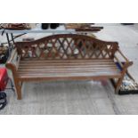 A LARGE WOODEN SLATTED THREE SEATER GARDEN BENCH