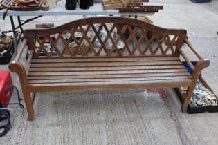 A LARGE WOODEN SLATTED THREE SEATER GARDEN BENCH