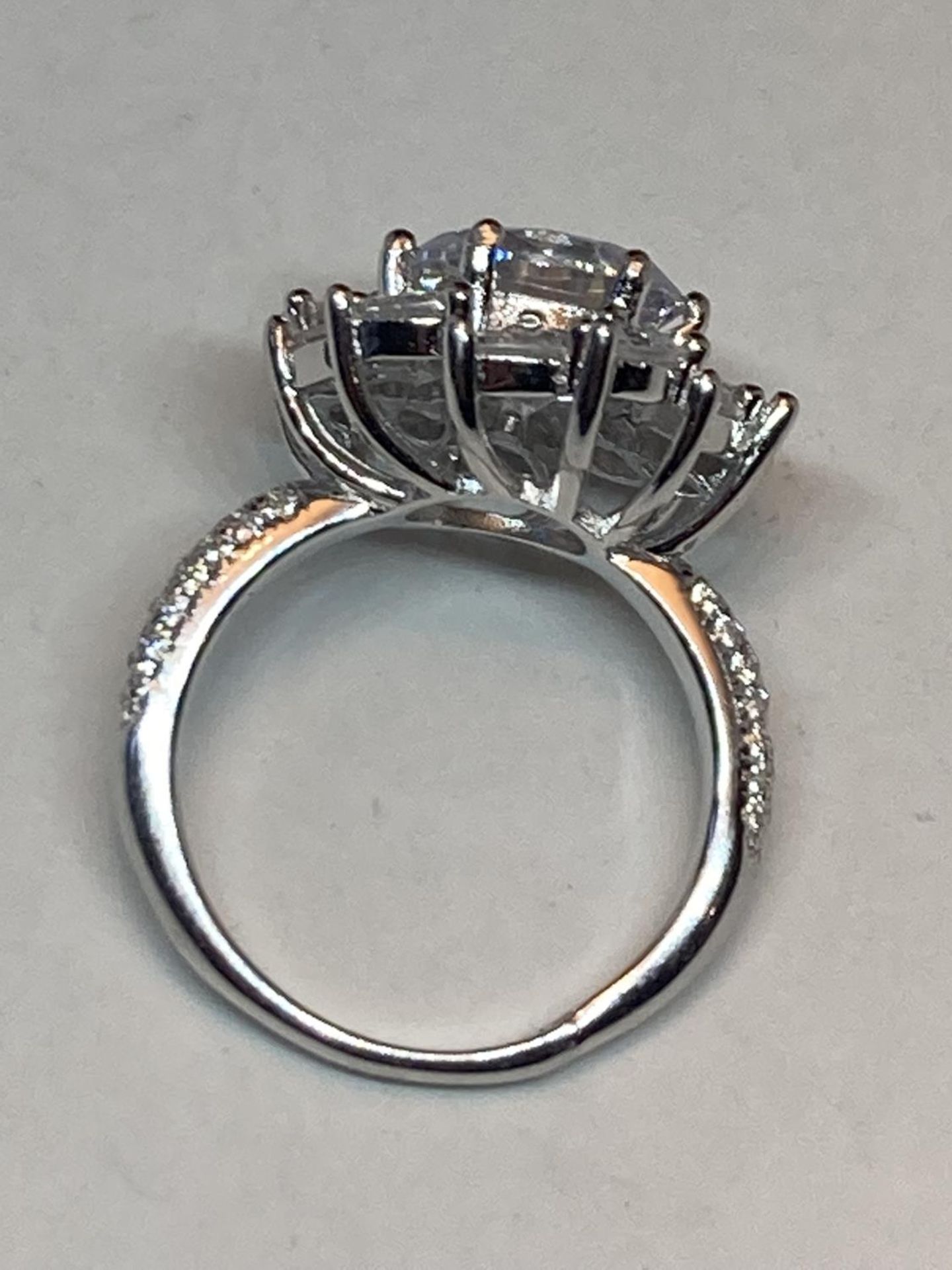A WHITE METAL RING WITH 3 CARATS OF MOISSANITE STONES IN A FLOWER DESIGN AND ON THE SHOULDERS SIZE N - Image 6 of 8