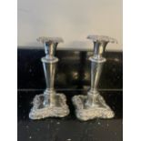 A PAIR OF HALLMARKED BIRMINGHAM SILVER CANDLESTICKS ONE WITH WEIGHTED BASE