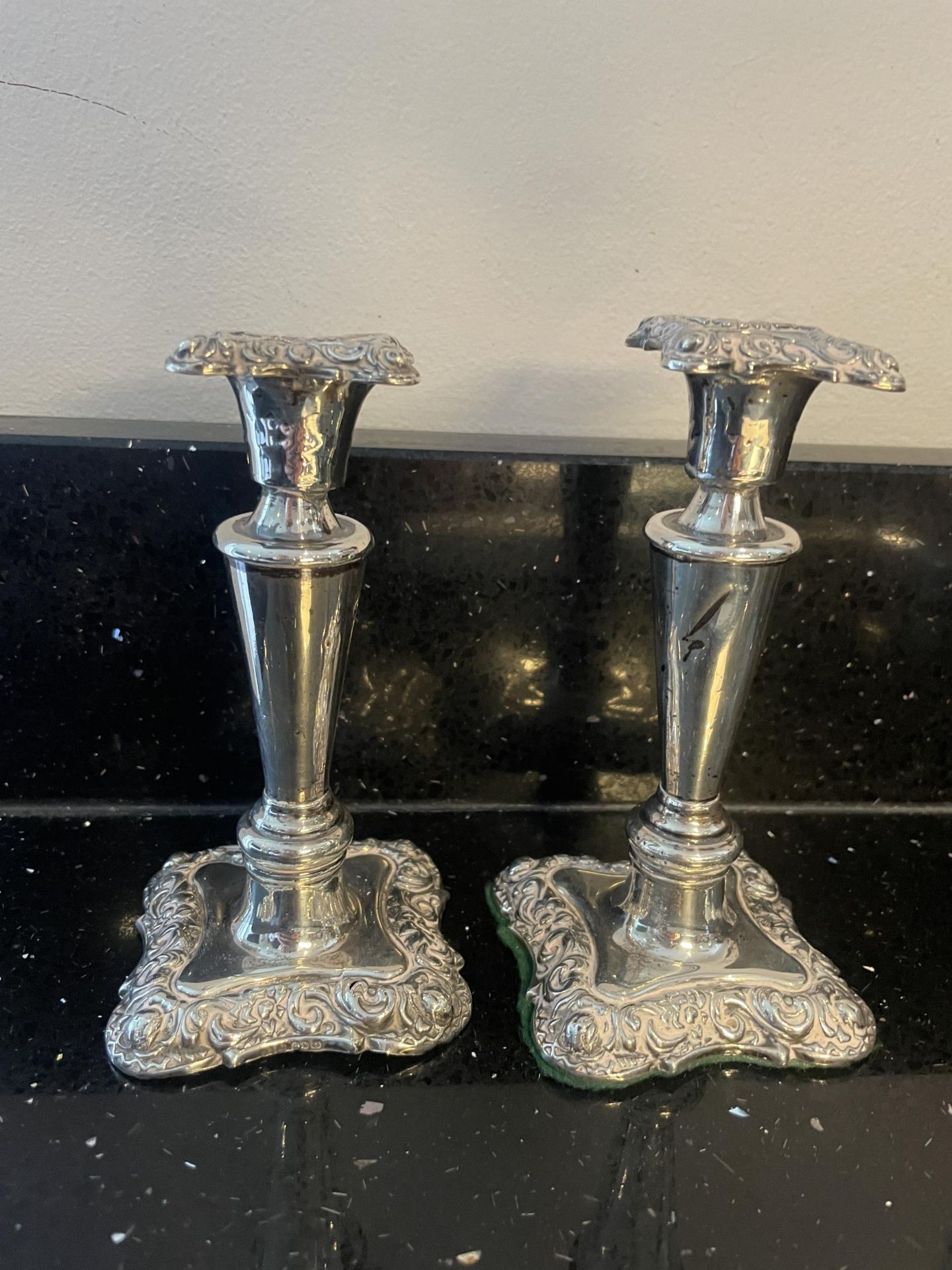 A PAIR OF HALLMARKED BIRMINGHAM SILVER CANDLESTICKS ONE WITH WEIGHTED BASE