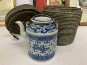 AN ANTIQUE BLUE AND WHITE CHINESE TEAPOT IN ORIGINAL BASKET