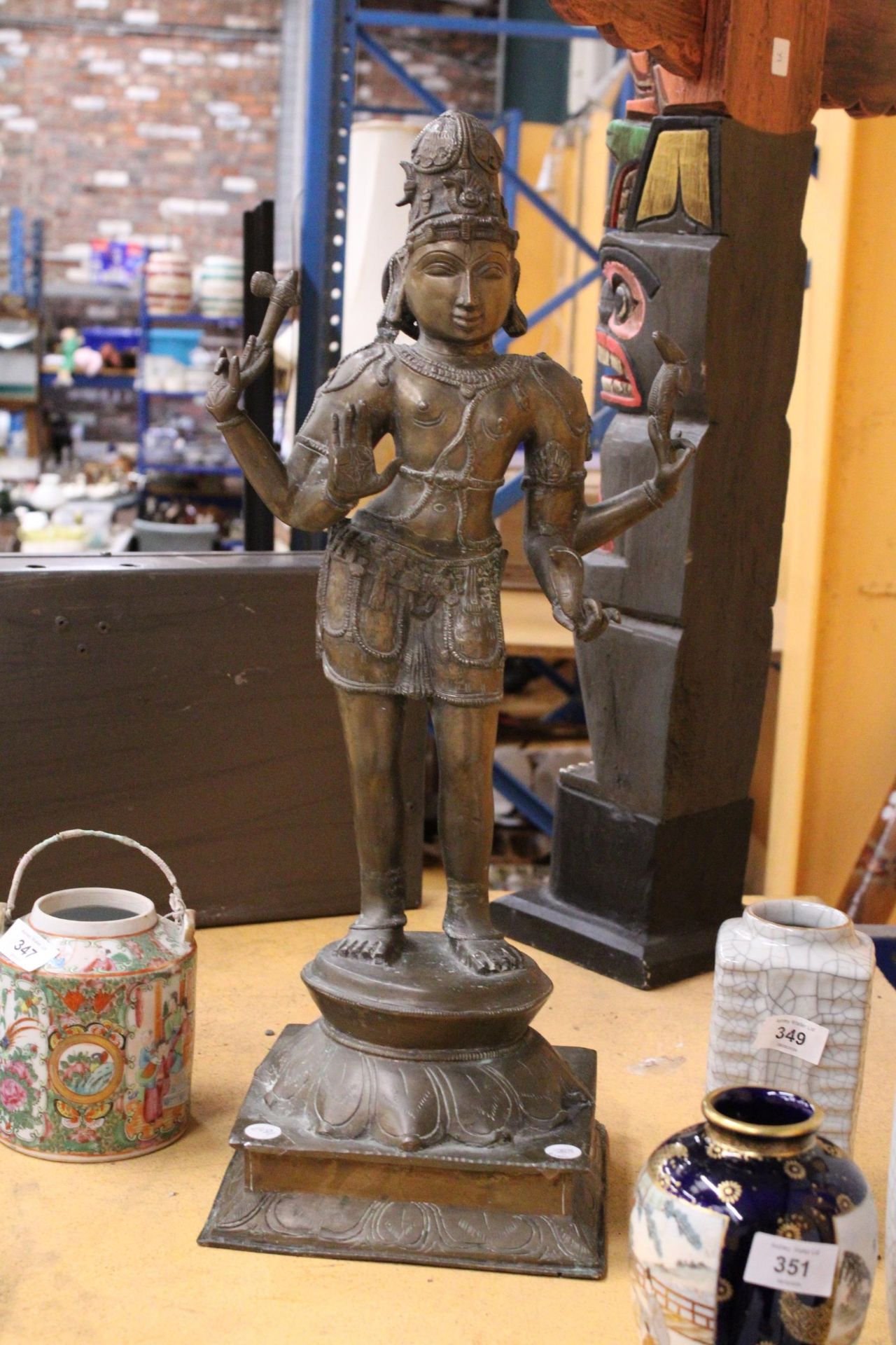 A LARGE SINO-TIBETAN BRONZE FIGURE OF AVALOKITESVARA WITH FOUR EXTENDING ARMS RAISED ON A LOBED