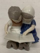A BING AND GRONDAHL FIGURE OF CHILDREN READING A BOOK
