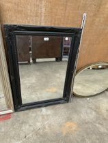 A RECTANGULAR BLACK FRAMED MIRROR