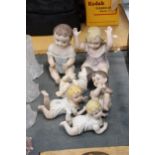 TWO LARGE AND FOUR SMALL ANTIQUE PORCELAIN BISQUE DOLLS