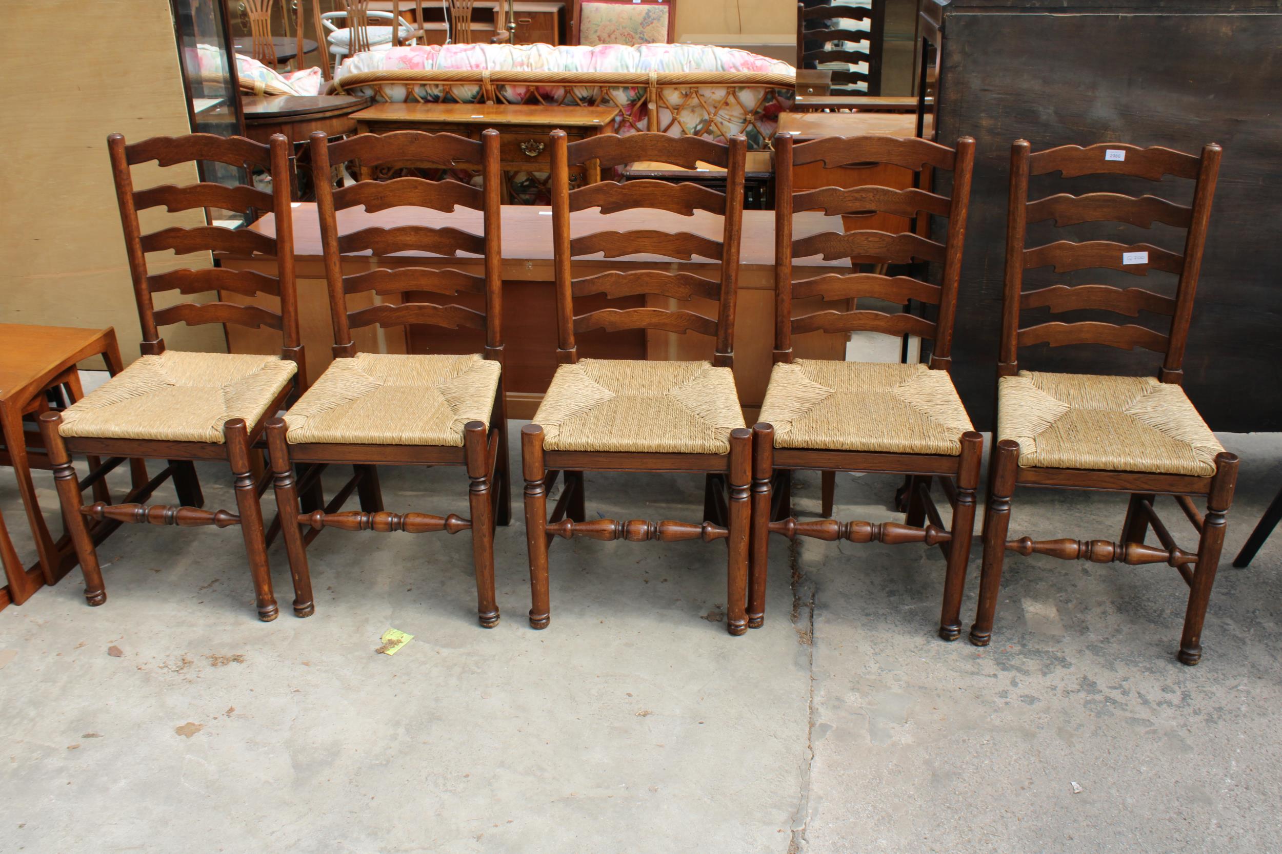 A SET OF FIVE ELM AND BEECH LANCASHIRE STYLE DINING CHAIRS WITH LADDER-BACKS AND RUSH SEATS