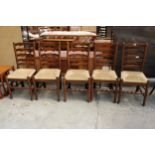 A SET OF FIVE ELM AND BEECH LANCASHIRE STYLE DINING CHAIRS WITH LADDER-BACKS AND RUSH SEATS