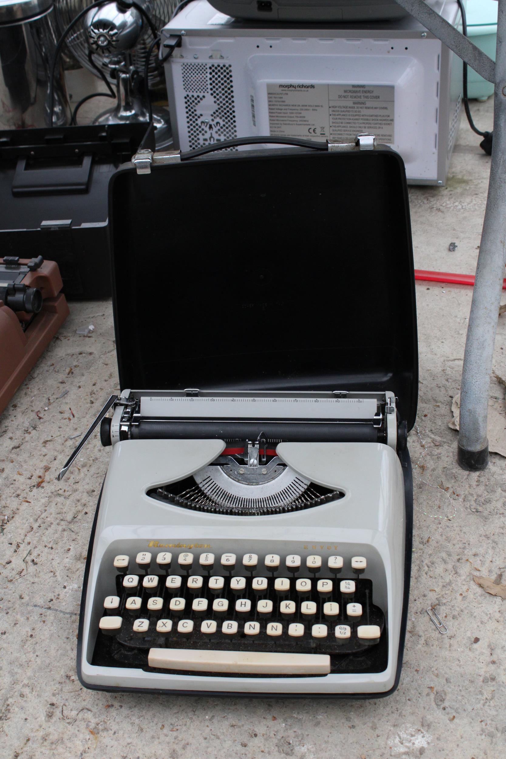 A VINTAGE REMMINGTON TYPEWRITER WITH CARRY CASE