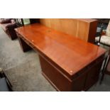 A MODERN PARTNERS/BANKERS DESK ENCLOSING SEVERAL DRAWERS, CUPBOARD AND WIRE DIRECTOR, 99" X 33"