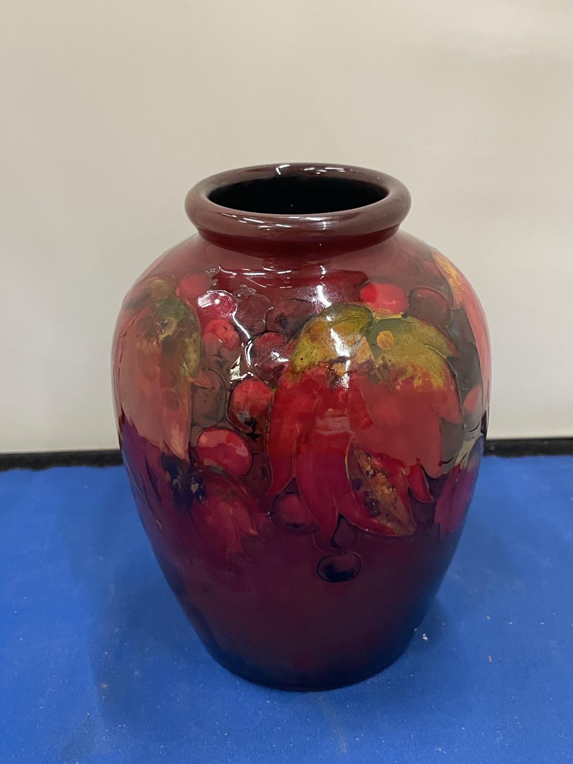 A MOORCROFT FLAMBE LEAF AND BERRY DESIGN VASE