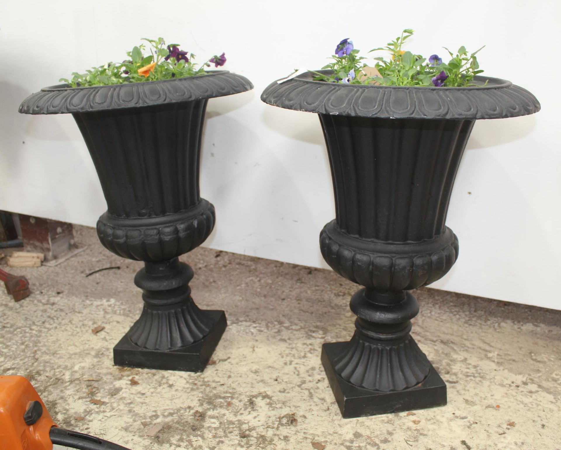 PAIR OF CAST IRON URNS WITH PLANTS NO VAT