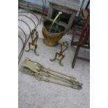 AN ASSORTMENT OF BRASS FIRE SIDE ITEMS TO INCLUDE A COAL BUCKET, FIRE DOGS AND TOOLS ETC