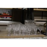 A QUANTITY OF CUT GLASS GLASSES TO INCLUDE CHAMPAGNE FLUTES, WHISKY, WINE, SHERRY, PORT, ETC