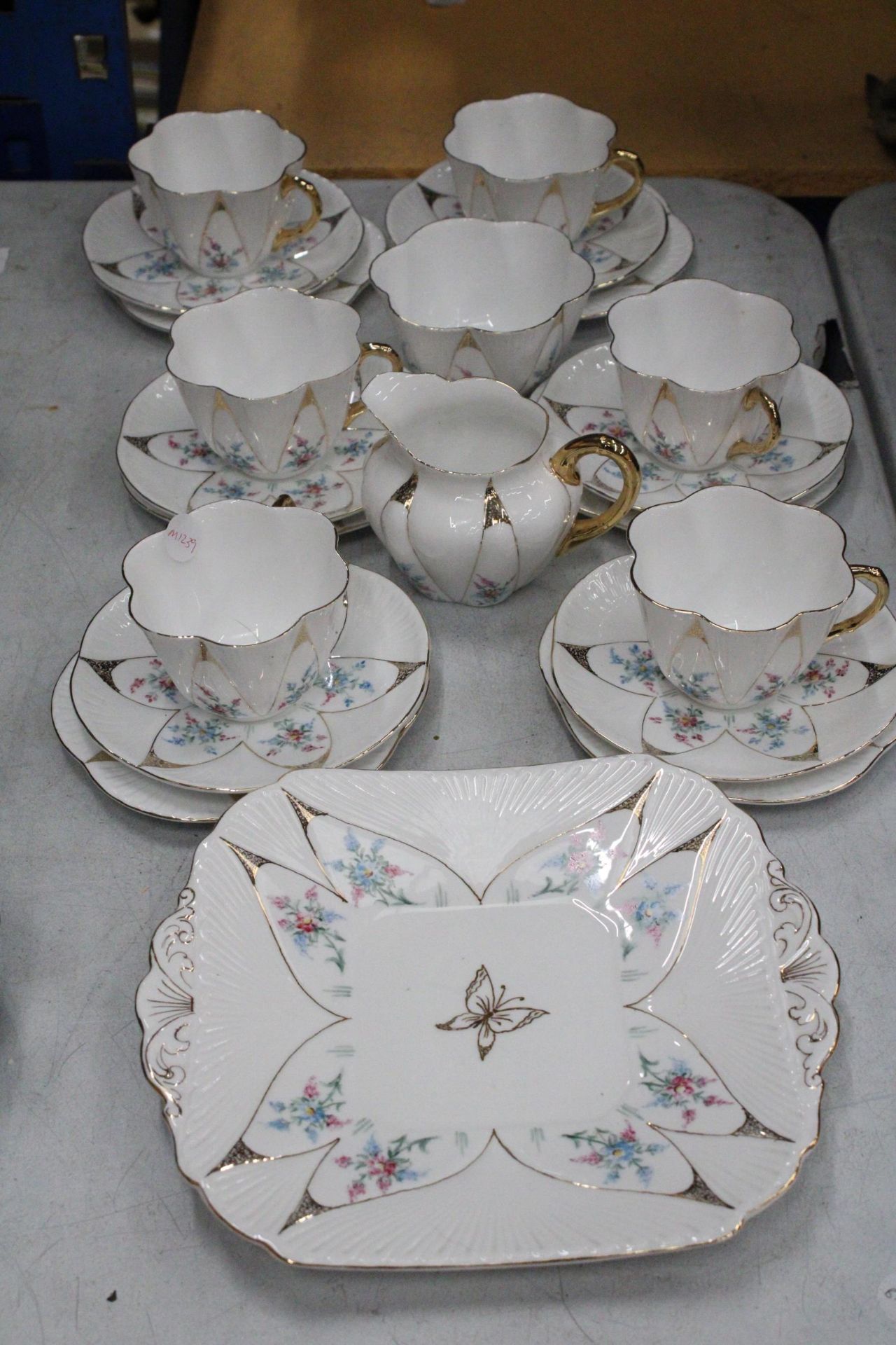 A VINTAGE SHELLEY HANDPAINTED DAINTY SHAPE TEACUPS AND SAUCERS TO INCLUDE SUGAR, CREAMER, CAKE/BREAD