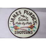 A CAST 'JAMES PURDEY SHOTGUNS' SIGN, DIAMETER, 22CM