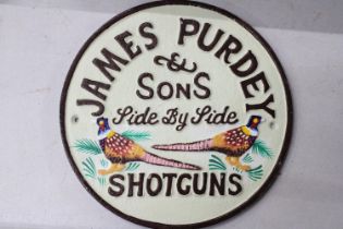 A CAST 'JAMES PURDEY SHOTGUNS' SIGN, DIAMETER, 22CM