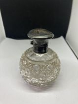 A CUT GLASS BOTTLE WITH A HALLMARKED BIRMINGHAM SILVER TOP