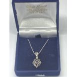 A SILVER NECKLACE WITH MARCASITE PENDANT IN A PRESENTATION BOX