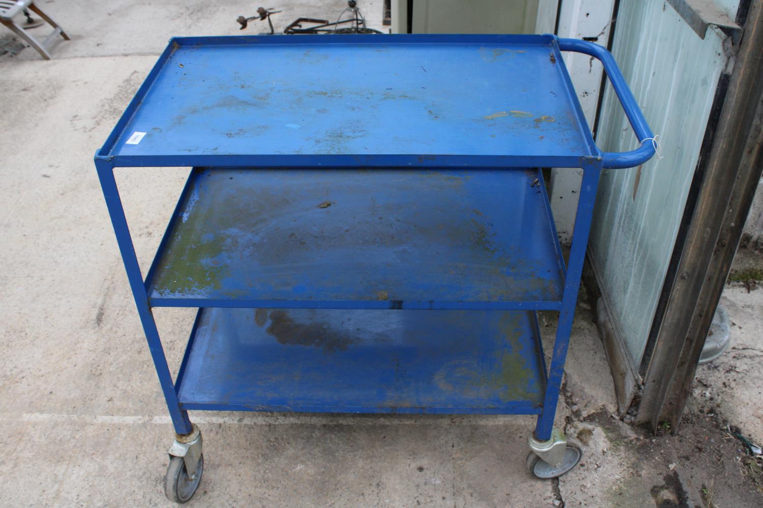 A FOUR WHEELED THREE TIER METAL WORKSHOP TROLLEY