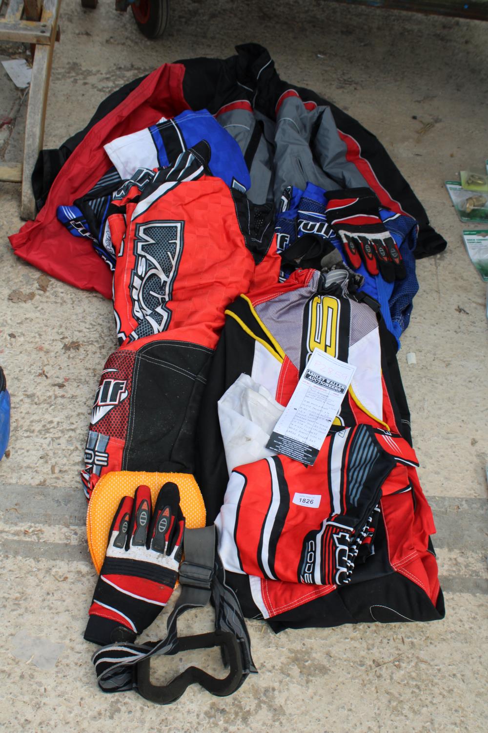 AN ASSORTMENT OF MOTORBIKE CLOTHING TO INCLUDE JACKETS, TROUSSERS AND GLOVES ETC