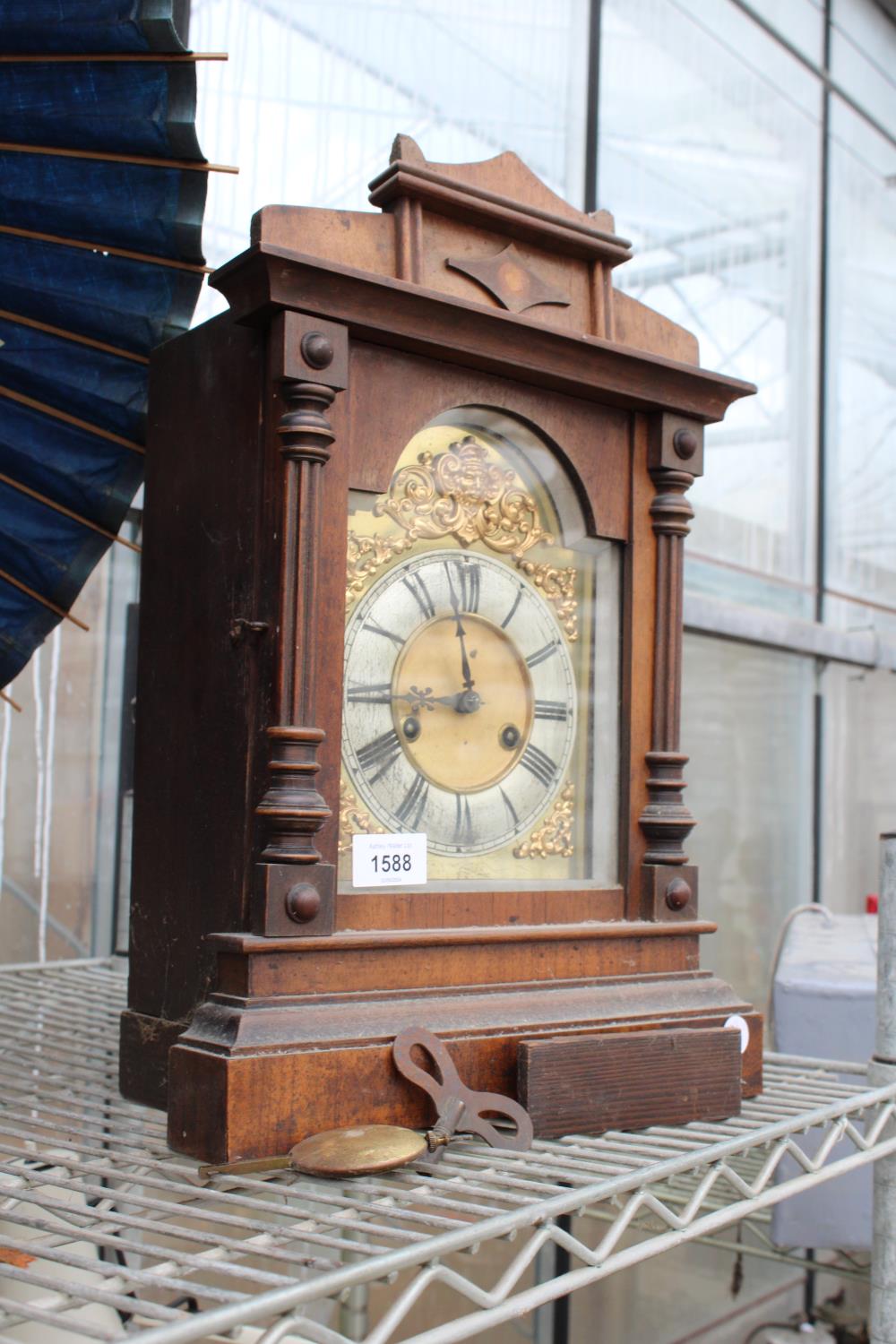 A DECORATIVE MAHOGANY CHIMING MANTLE CLOCK