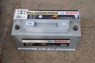 A BOSCH S5 013 CAR BATTERY BELIEVED FULLY CHARGED AND HOLDING CHARGE BUT NO WARRANTY