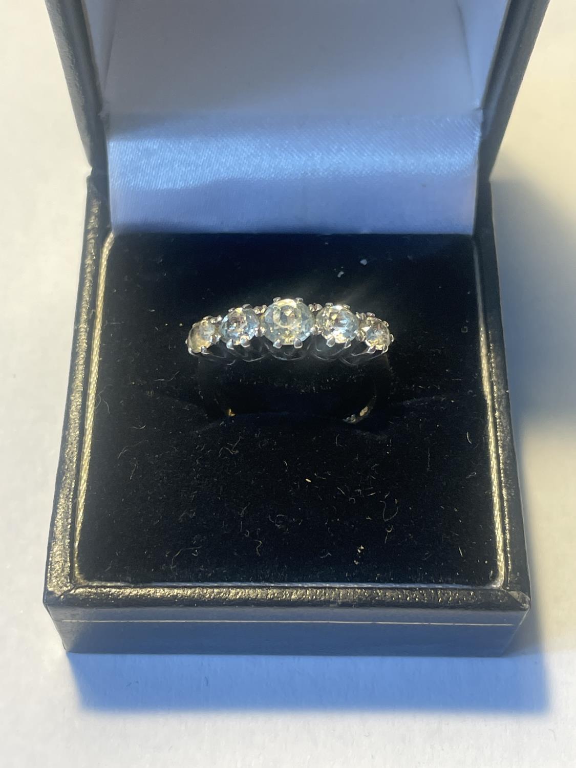 A SILVER AND 9 CARAT GOLD RING WITH FOVE IN LINE CLEAR STONES IN A PRESENTATION BOX