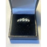 A SILVER AND 9 CARAT GOLD RING WITH FOVE IN LINE CLEAR STONES IN A PRESENTATION BOX