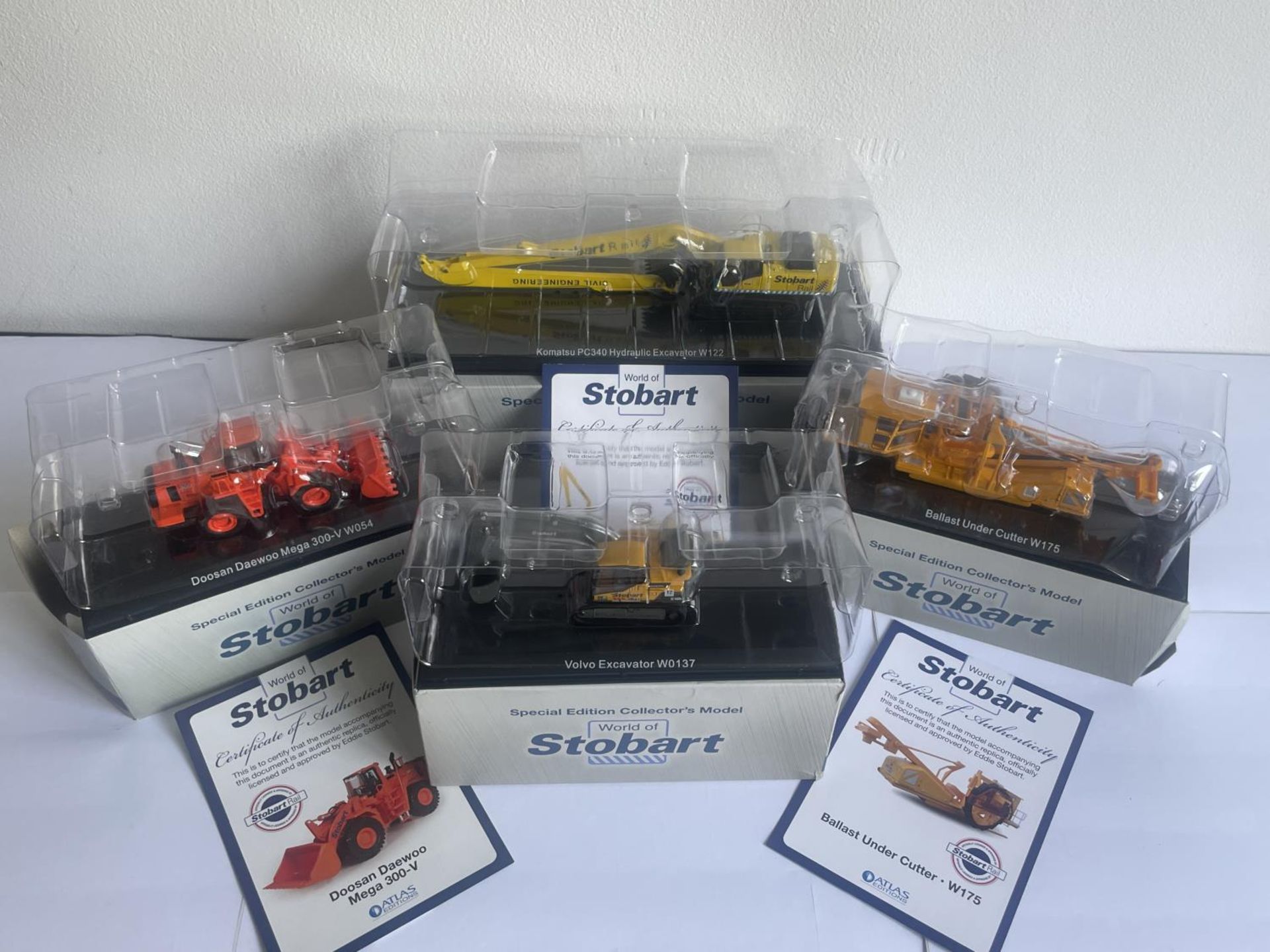 FOUR BOXED STOBART MODELS OF EXCAVATORS SOME WITH COA