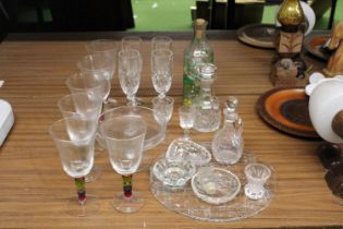 A LARGE QUANTITY OF GLASSWARE TO INCLUDE WINE GLASSES, VINEGAR BOTTLE WITH STOPPER, CHEESEBOARD,