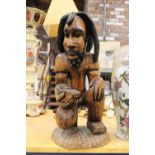 A LARGE, HEAVY, WOODEN TRIBAL STYLE CARVING, HEIGHT APPROX 52CM