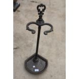 A DECORATIVE CAST IRON UMBRELLA STAND WITH DRIP TRAY