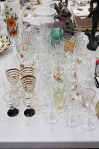 A QUANTITY OF GLASSWARE TO INCLUDE SHOT GLASSES, BEER GLASSES, WINE GLASSES, SHERRY GLASSES ETC