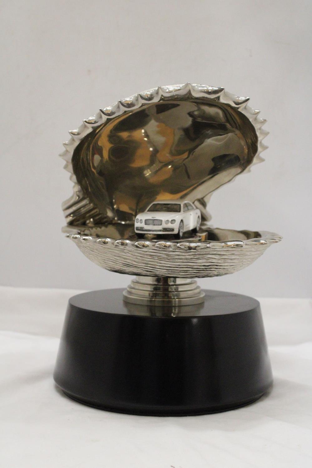 A LARGE CHROME OYSTER SHELL, ENCLOSING A BENTLEY CAR, ON A BASE, HEIGHT 30CM, DIAMETER APPROX 24CM - Image 2 of 6