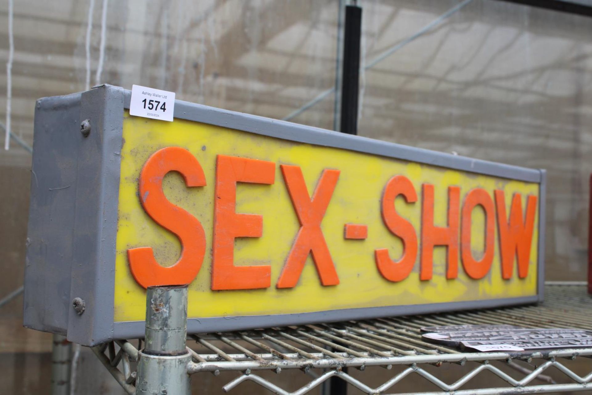 AN ILLUMINATED SEX SHOW SIGN