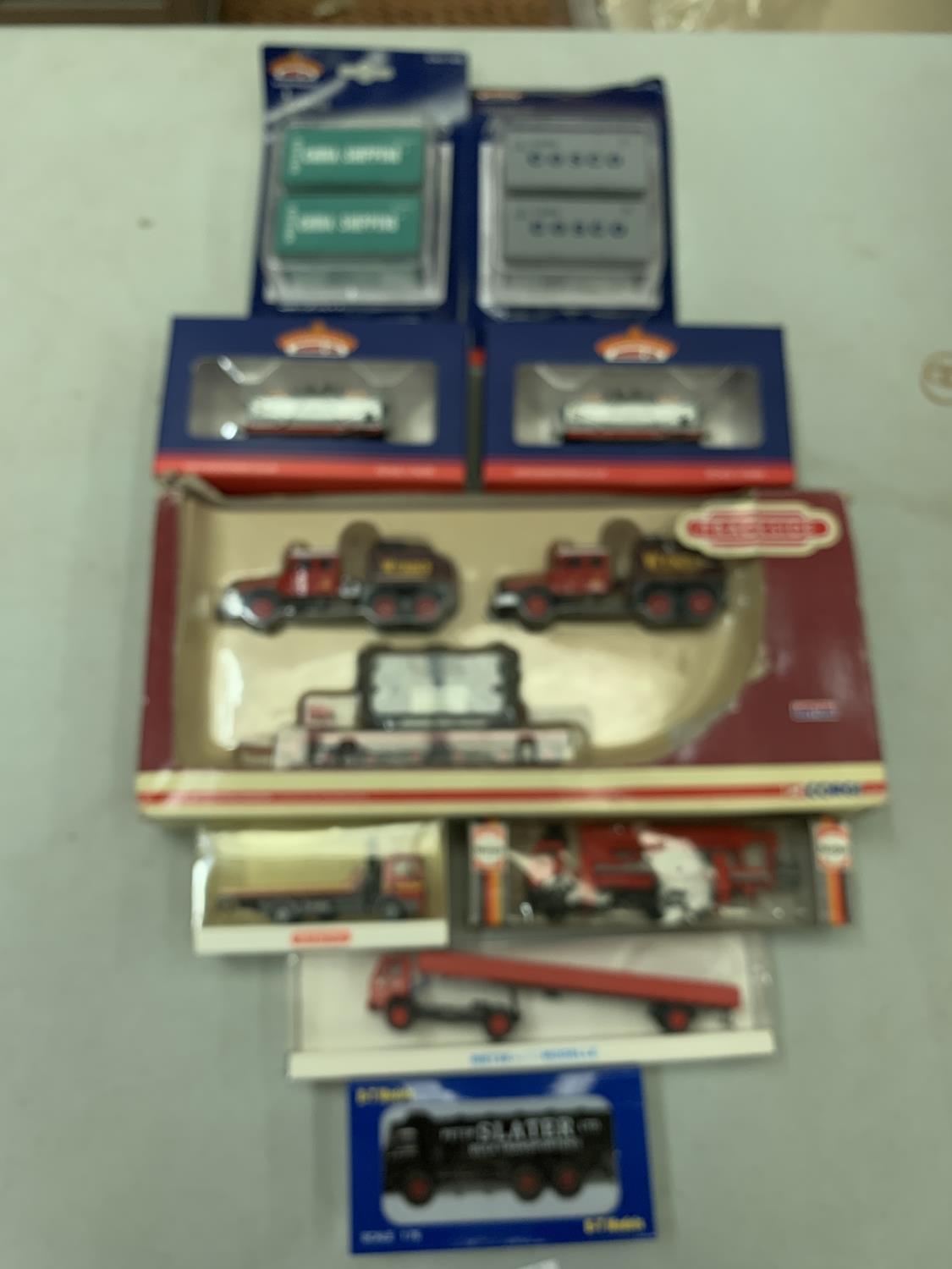 NINE BOXED TOY VEHICLES, TANKS AND SHIPPING CONTAINERS ETC. TO INCLUDE BACHMANN, HERPA ETC