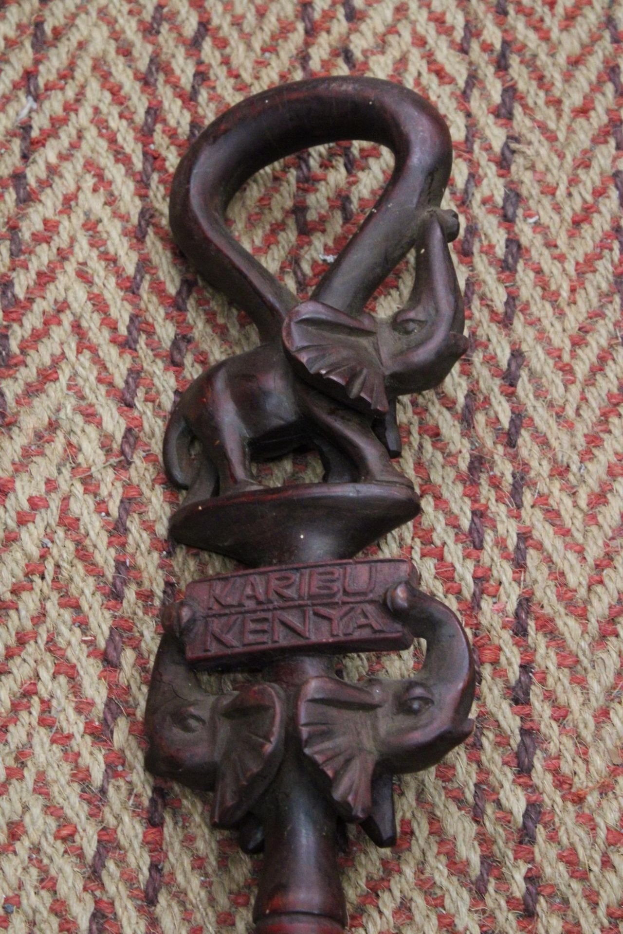 A HAND CARVED AFRICAN WALKING STICK, WITH ELEPHANT FIGURES TO THE TOP, WITH THE INSCRIPTION 'KARIBU, - Image 2 of 4