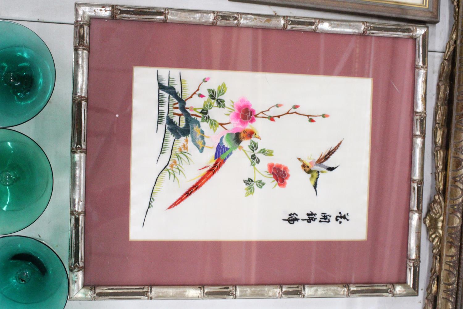 AN ORIENTAL SILK HAND EMBROIDERED ART PIECE IN BAMBOO FRAME