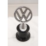 A CHROME VW LOGO ON A BASE, HEIGHT 21CM