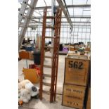 A VINTAGE 27 RUNG WOODEN THREE SECTION EXTENDING LADDER