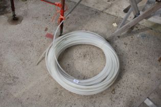 A COIL OF THIN WHITBREAD IRIGATION PIPE