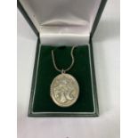 A SILVER NECKLACE AND LOCKET IN A PRESENTATION BOX